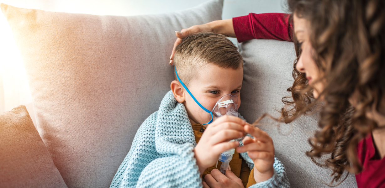 Young boy receiving assistance in the use of a nebuliser at home A young boy receiving assistance in the use of a nebuliser at home