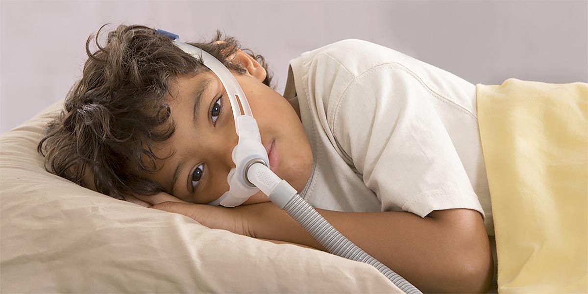 child with sleeping apnea and CPAP machine child with sleeping apnea and CPAP machine