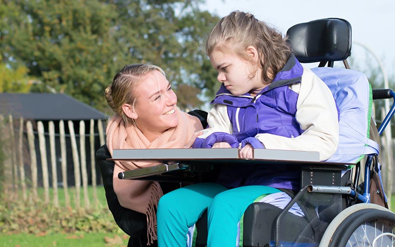 Girl and her carer outdoors