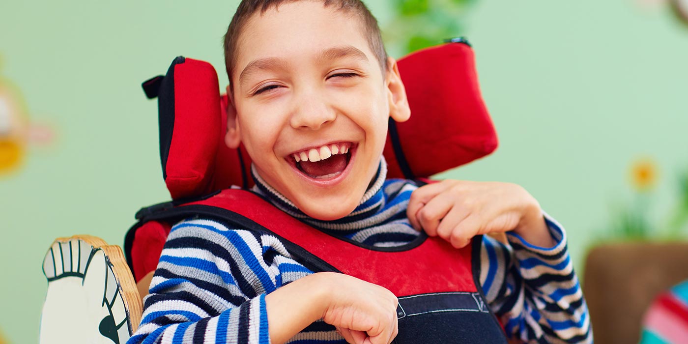 Smiling child in a wheelchair Smiling child in a wheelchair